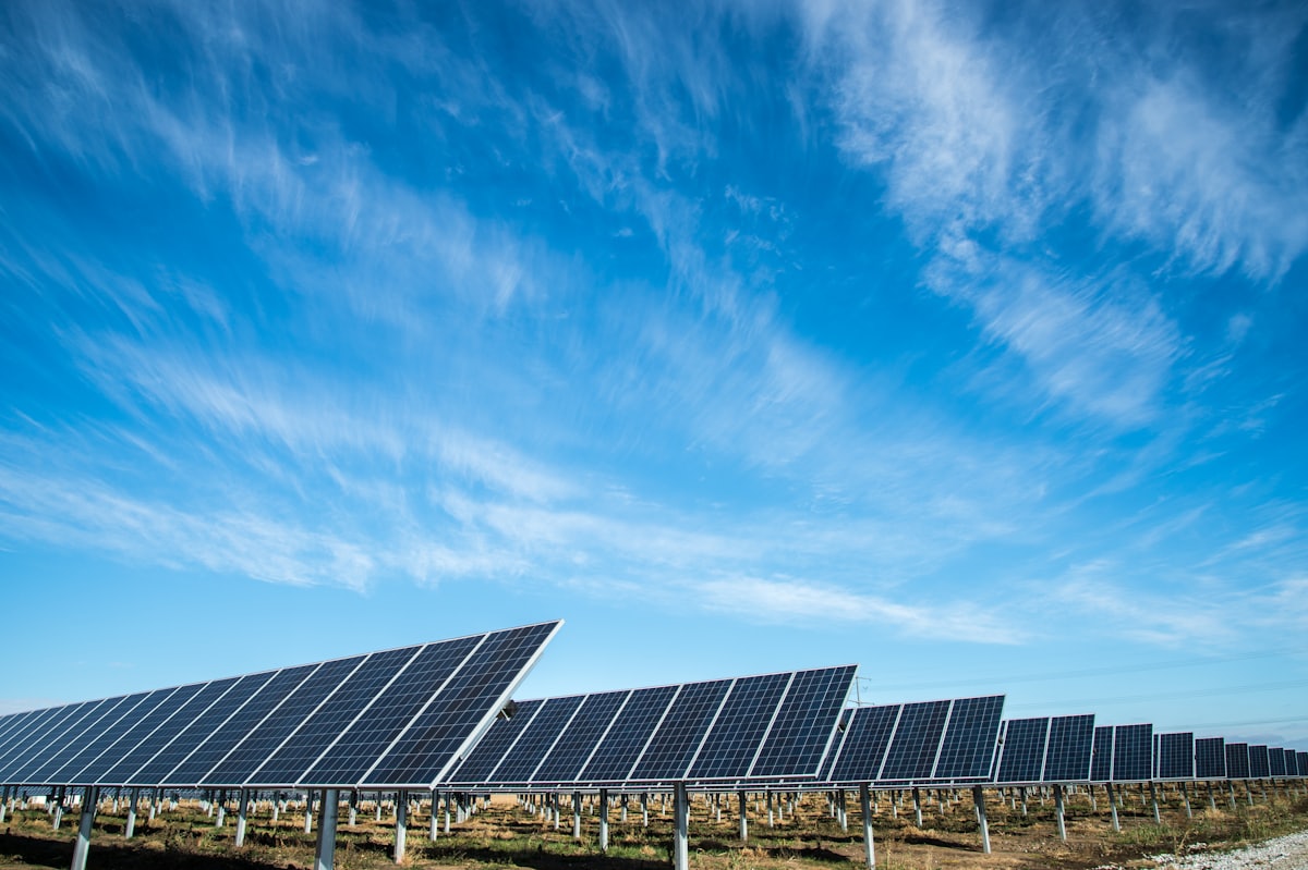 Ground-mounted solar array under a dramatic sky