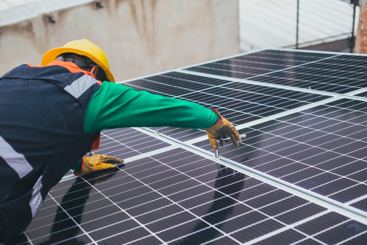 Technician working on photovoltaic modules on site